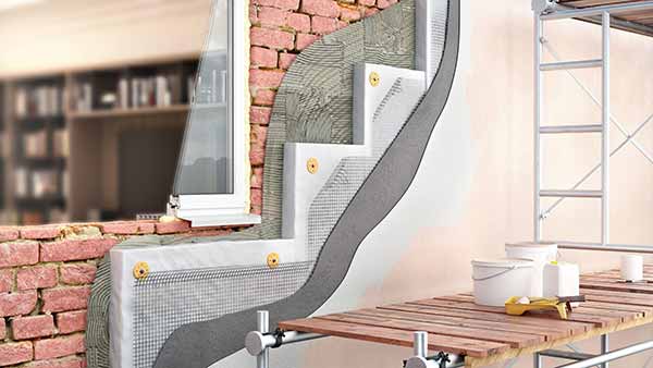 Home insulation being installed in walls to improve thermal performance and reduce heat loss